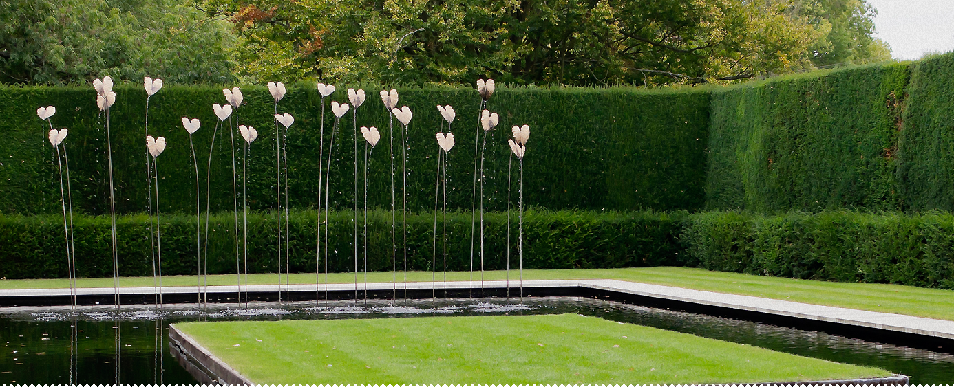 Formal landscaped garden with clipped hedges and water feature